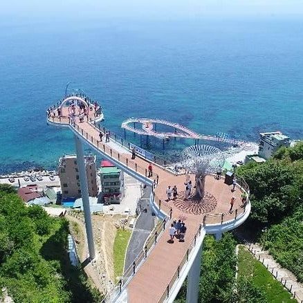 A skywalk looping out over the sea, seen from above